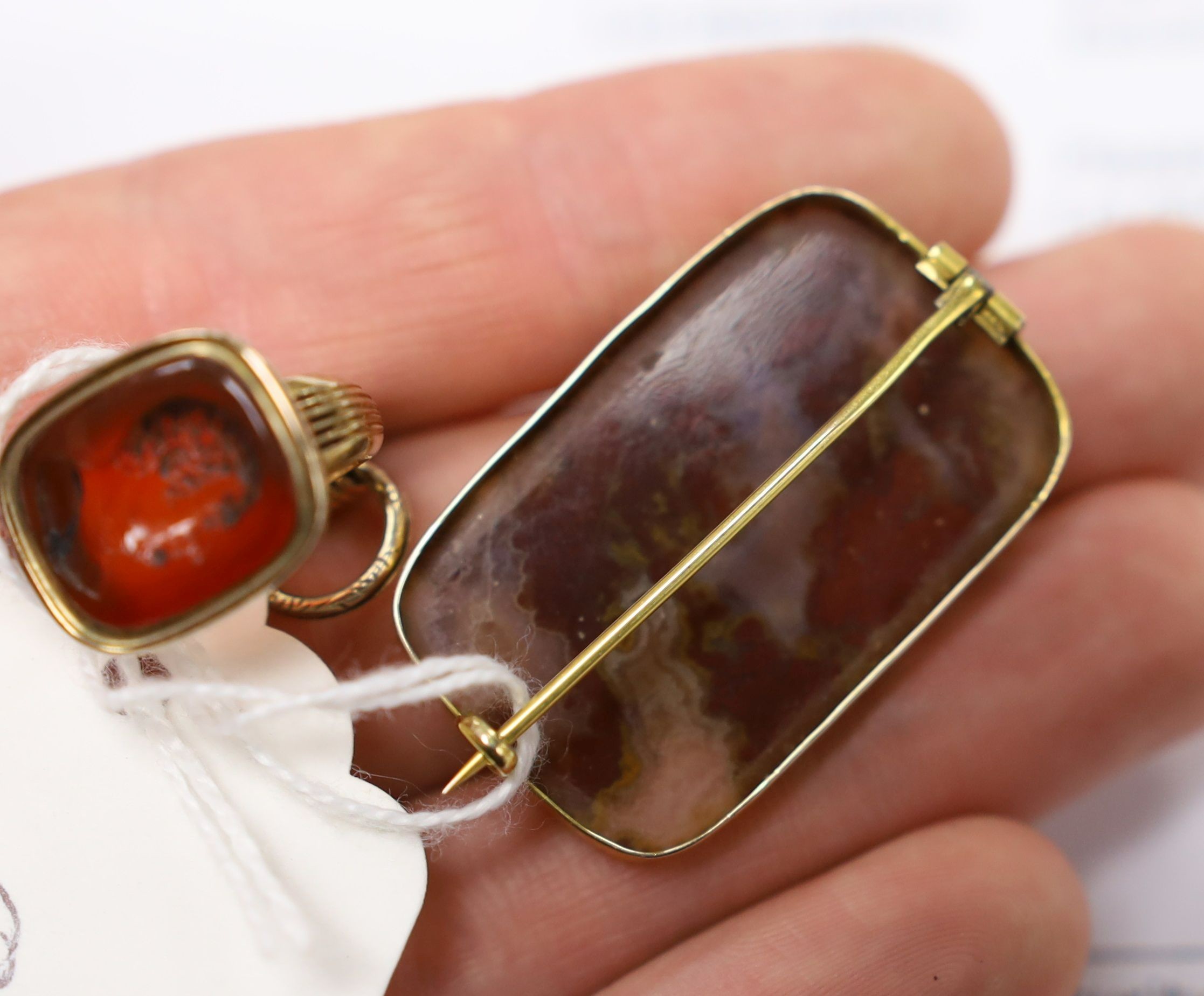 A Victorian yellow metal overlaid seal and and intaglio carnelian set seal, 21mm and a yellow metal and agate set brooch.